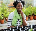 Lekeah A. Durden in a greenhouse with plants